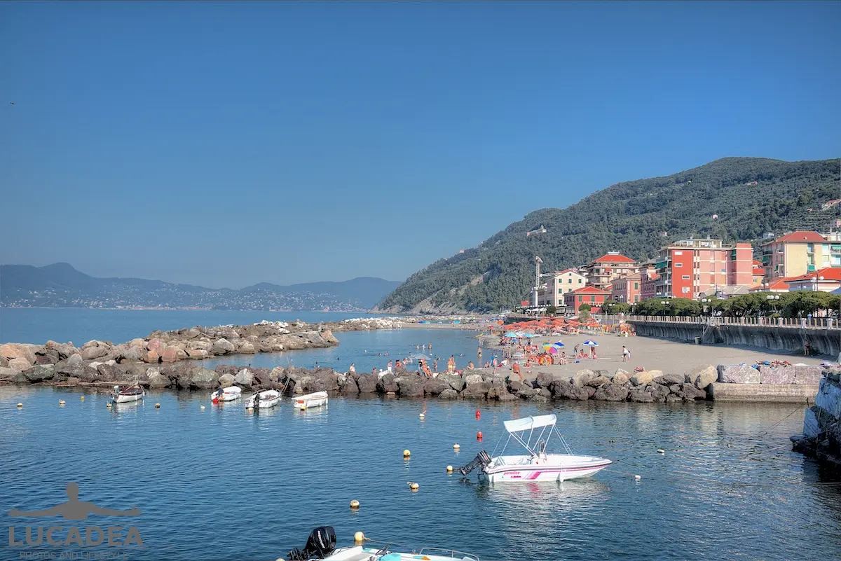 Chiavari Beach seen from the seafront, with the sea, rocks and breakwaters along the Ligurian coast