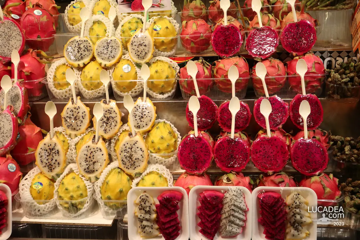 Fresh fruit displayed at La Boqueria in Barcelona, with mango, dragonfruit, strawberries and other produce